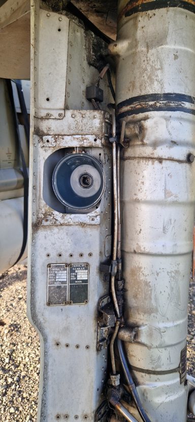 Close-up of machinery components with wires and a circular part.