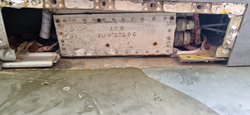 Rusty machinery with exposed components and a concrete surface beneath.