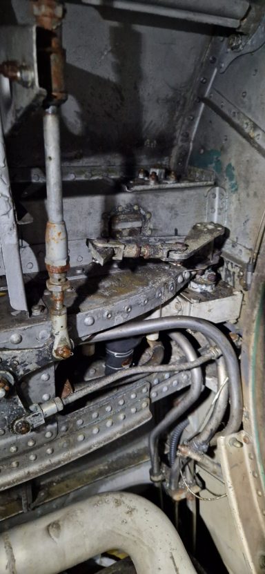 Close-up of mechanical components inside a machine with various pipes and fittings.